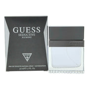 Guess Guess Seductive Homme Eau de Toilette 50 ml, mørkeblå rektangulær flakon i riflet glas med sølvlogo og sort låg